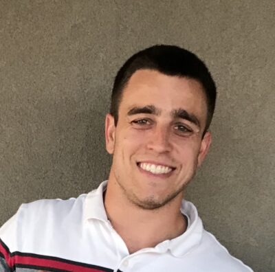 A young man smiling towards camera