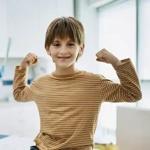 A Boy Smiling while making a victory appearance